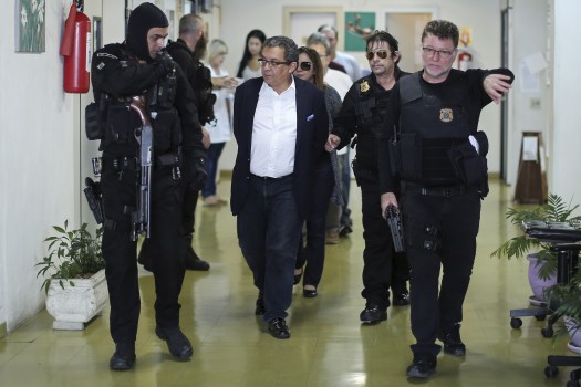 Brazilian President Dilma Rousseff and former Brazilian President (2003-2011) Luiz Inacio Lula Da Silva's campaign publicist Joao Santana (C) is arrested upon his arrival in Sao Paulo, Brazil o February 23, 2016. Political consultant Santana was being investigated by the Brazilian justice for receiving payments outside the country which could come from Brazilian state-run oil company Petrobras' briberies. AFP PHOTO / STR